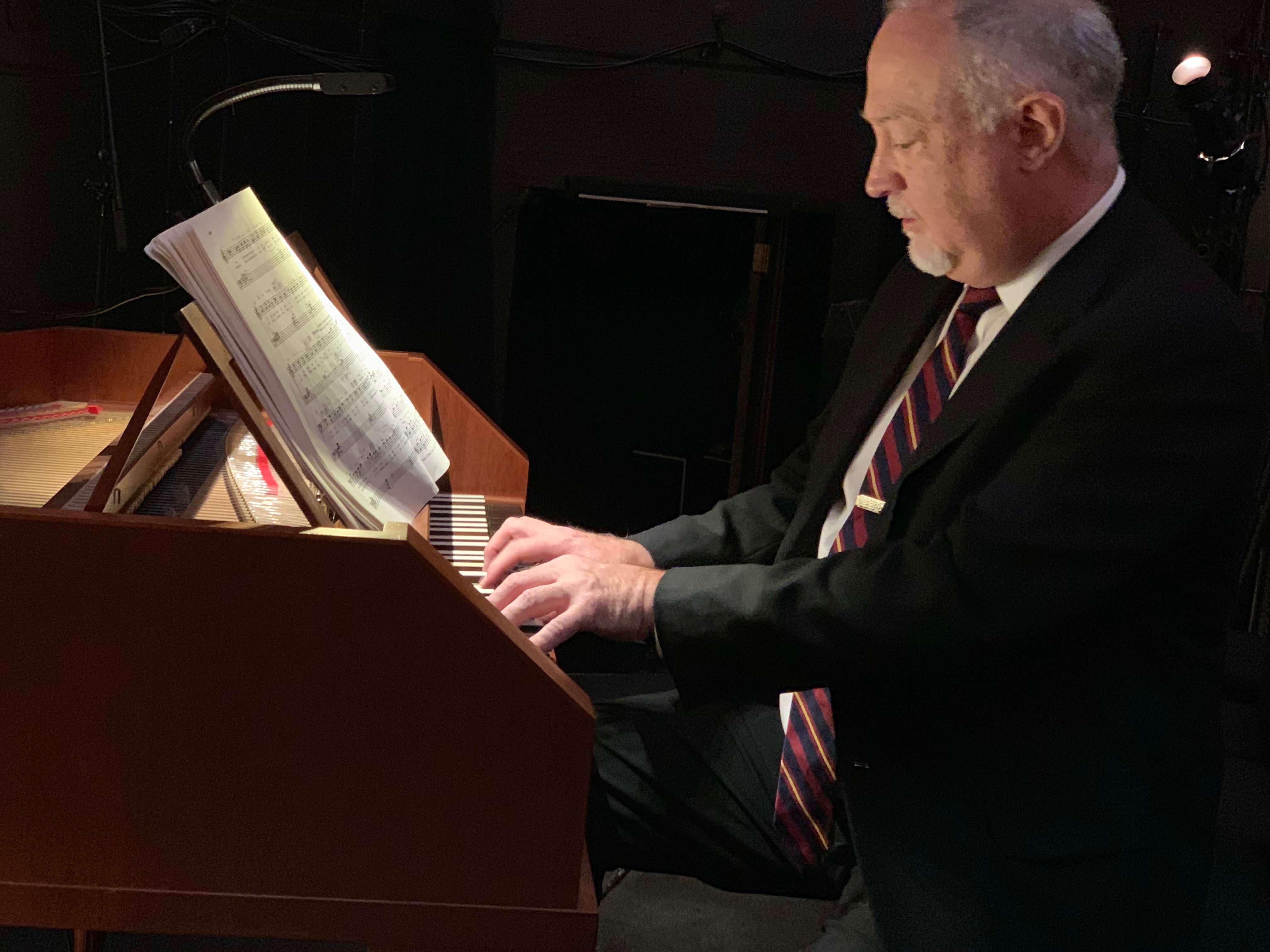 Bryndon Hassman playing continuo in Figaro.