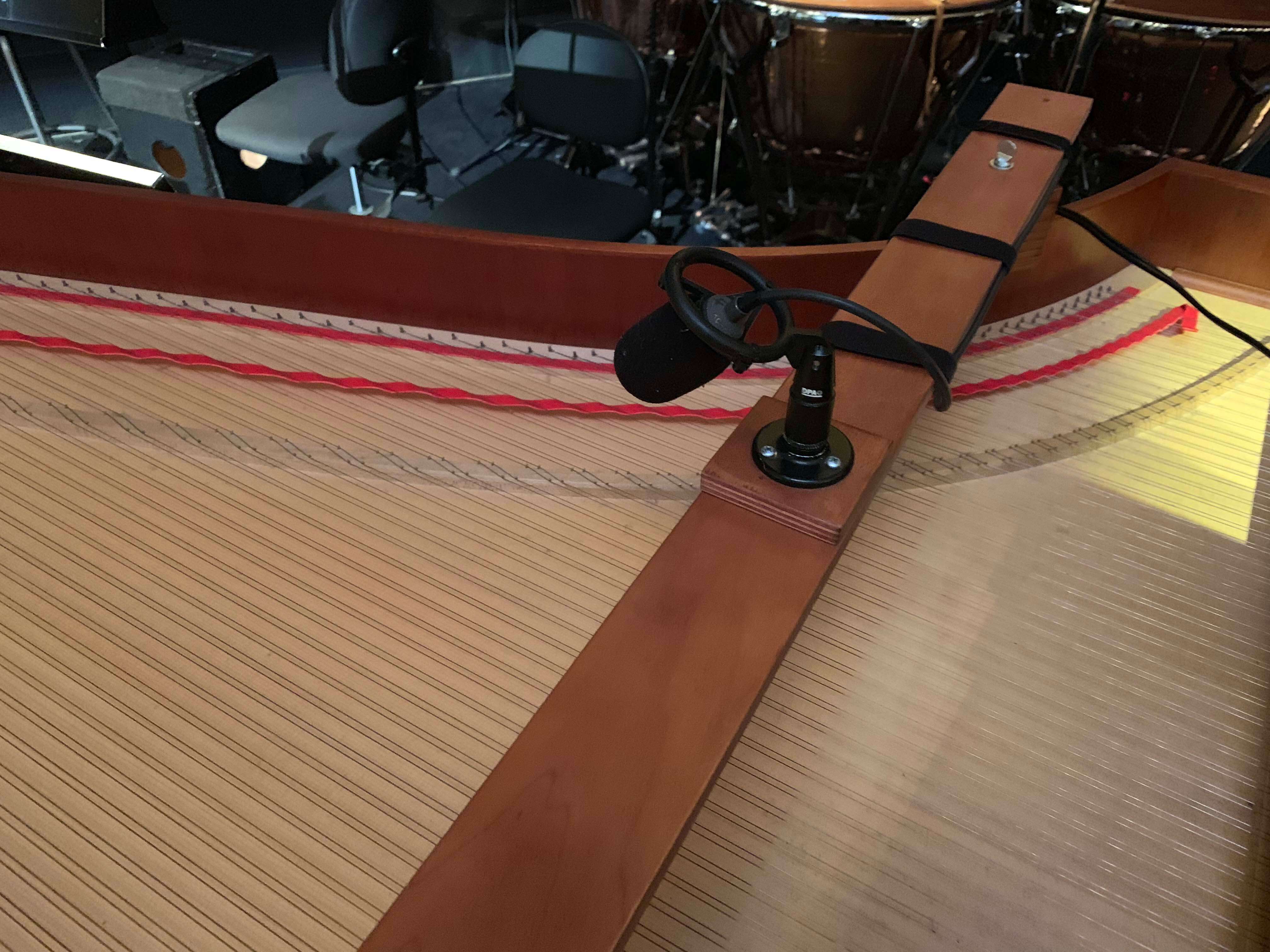 As the continuo fortepiano is not the loudest instrument and doesn&rsquo;t always carry naturally back towards the stage, we relay it back onto the stage through &lsquo;monitors&rsquo; so that the singers can hear it more clearly. Here you can see the microphone that will pick up the instrument.