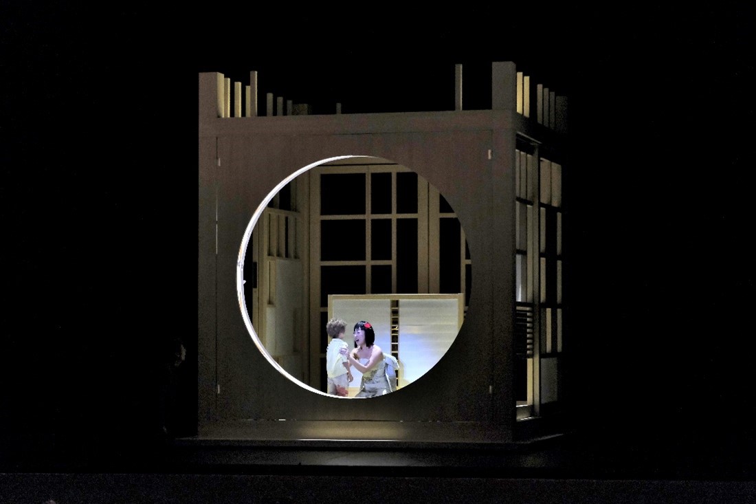 A woman looking at a boy on a custom stage.