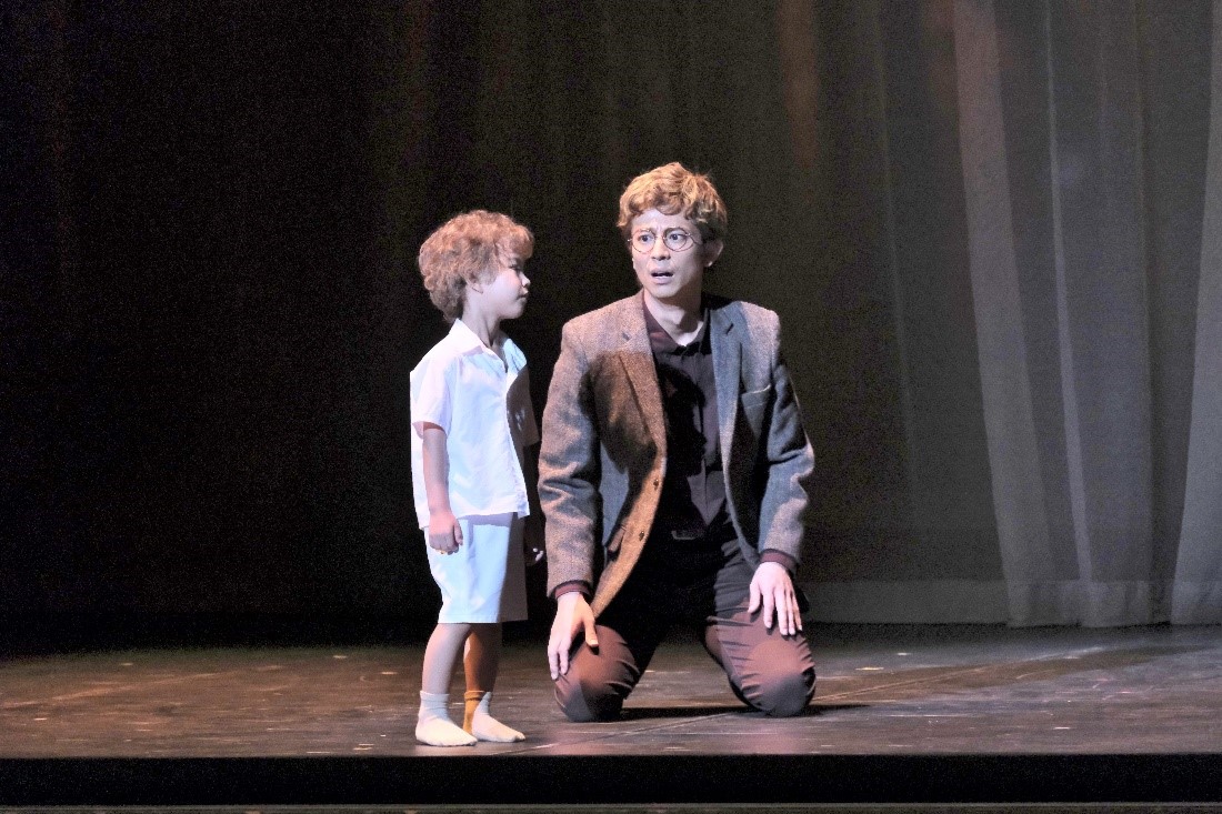 A man and a boy on stage