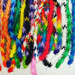 multi colored origami swan's stringed together.