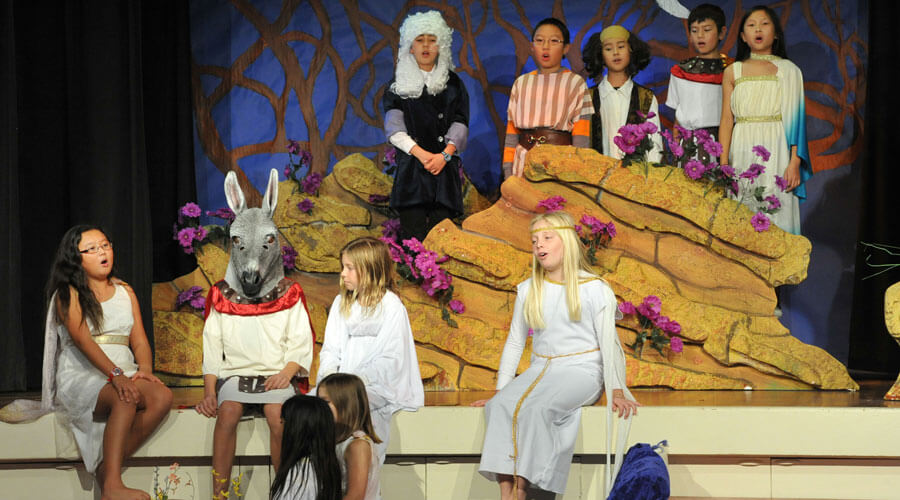 Children in costumes on stage