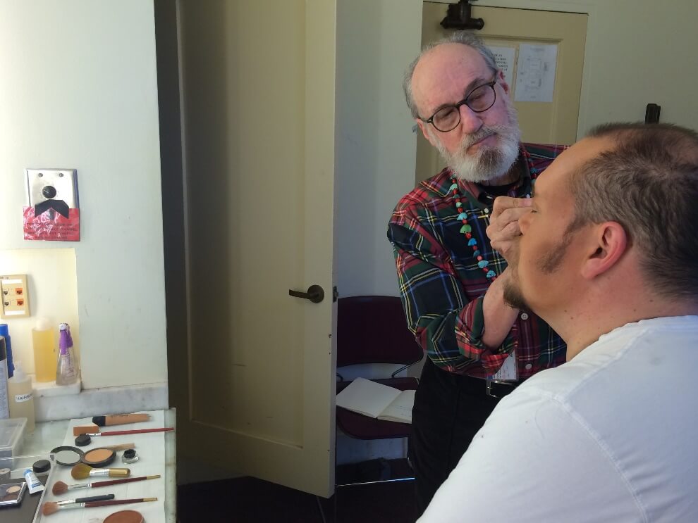 Bill applying highlights to Quinn in advance of Rigoletto.