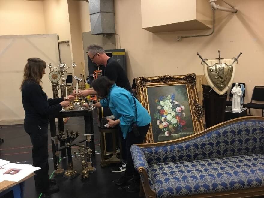 Lori Harrison, Robert Innes Hopkins and Sarah Shores in an impromptu meeting to talk about desk drawers; Patricia Hewett, Robert and Lori working out the arrangement of items in Scarpia’s bribery haul in Act II.