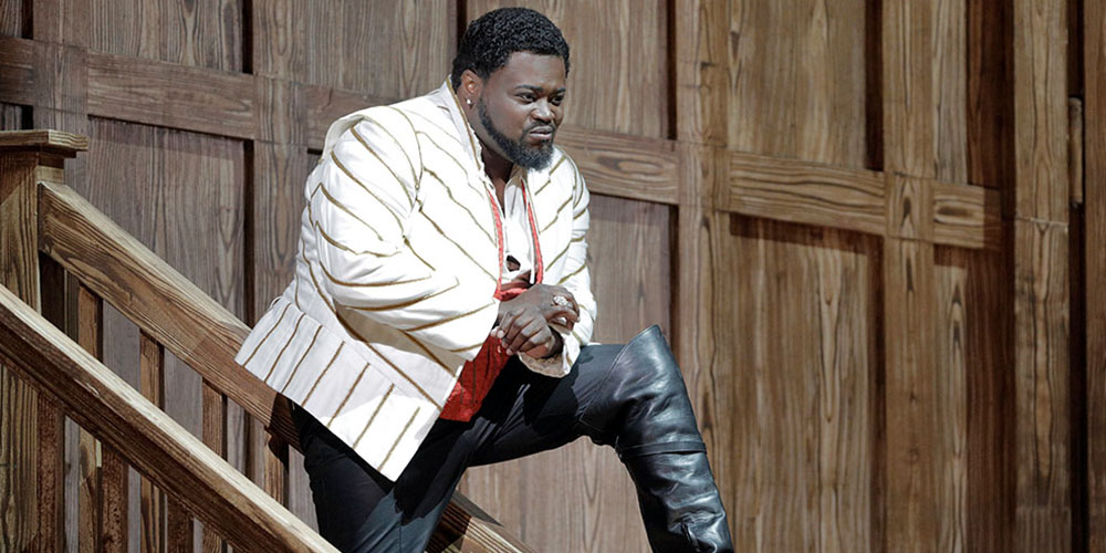 Russell Thomas posing on a staircase