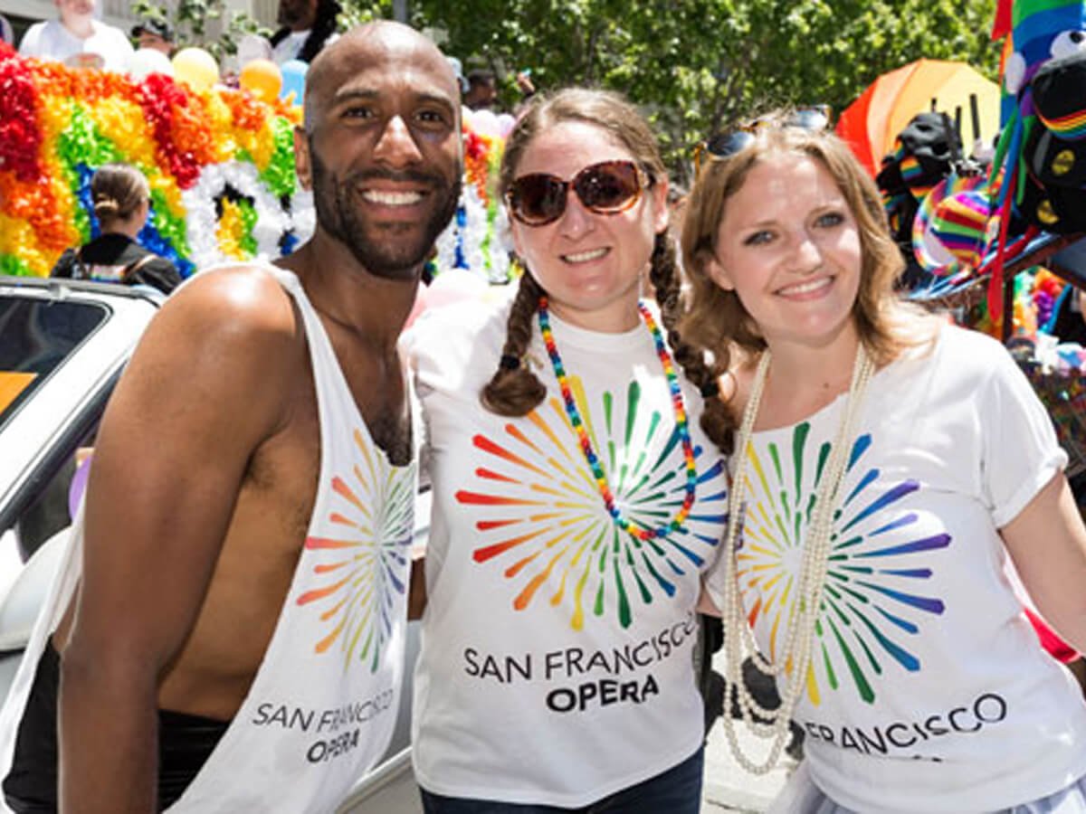 Three people in SF Opera shirts at the Pride Parade