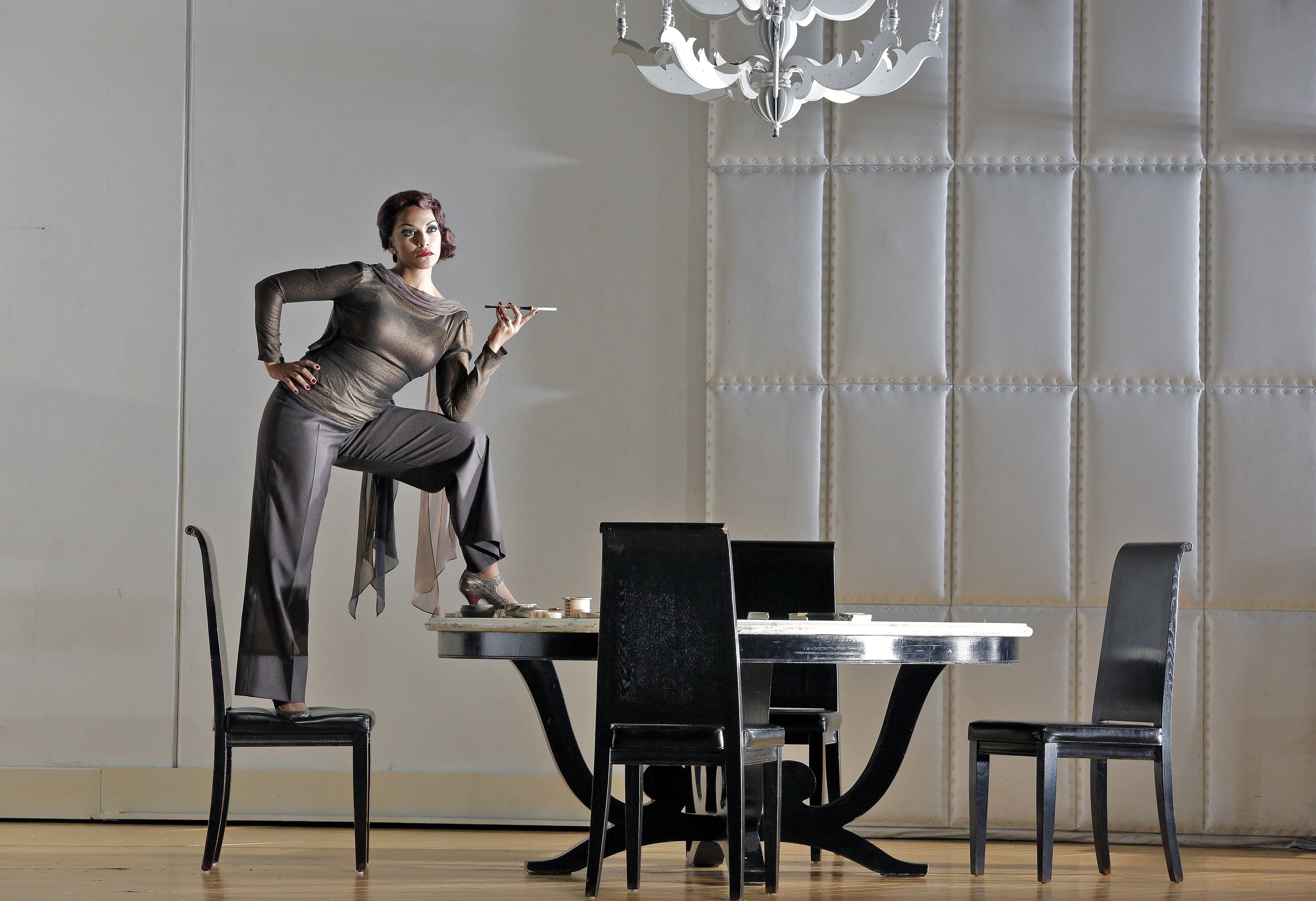 Partenope standing on a chair with her foot on the table