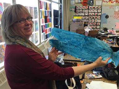 San Francisco Opera Director of Education Ruth Nott with a prop fish from one of the ARIA classes at Thomas Edison Elementary.