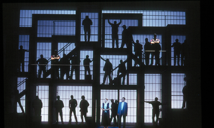 A state that appears to be a prison with people behind bars at multiple levels