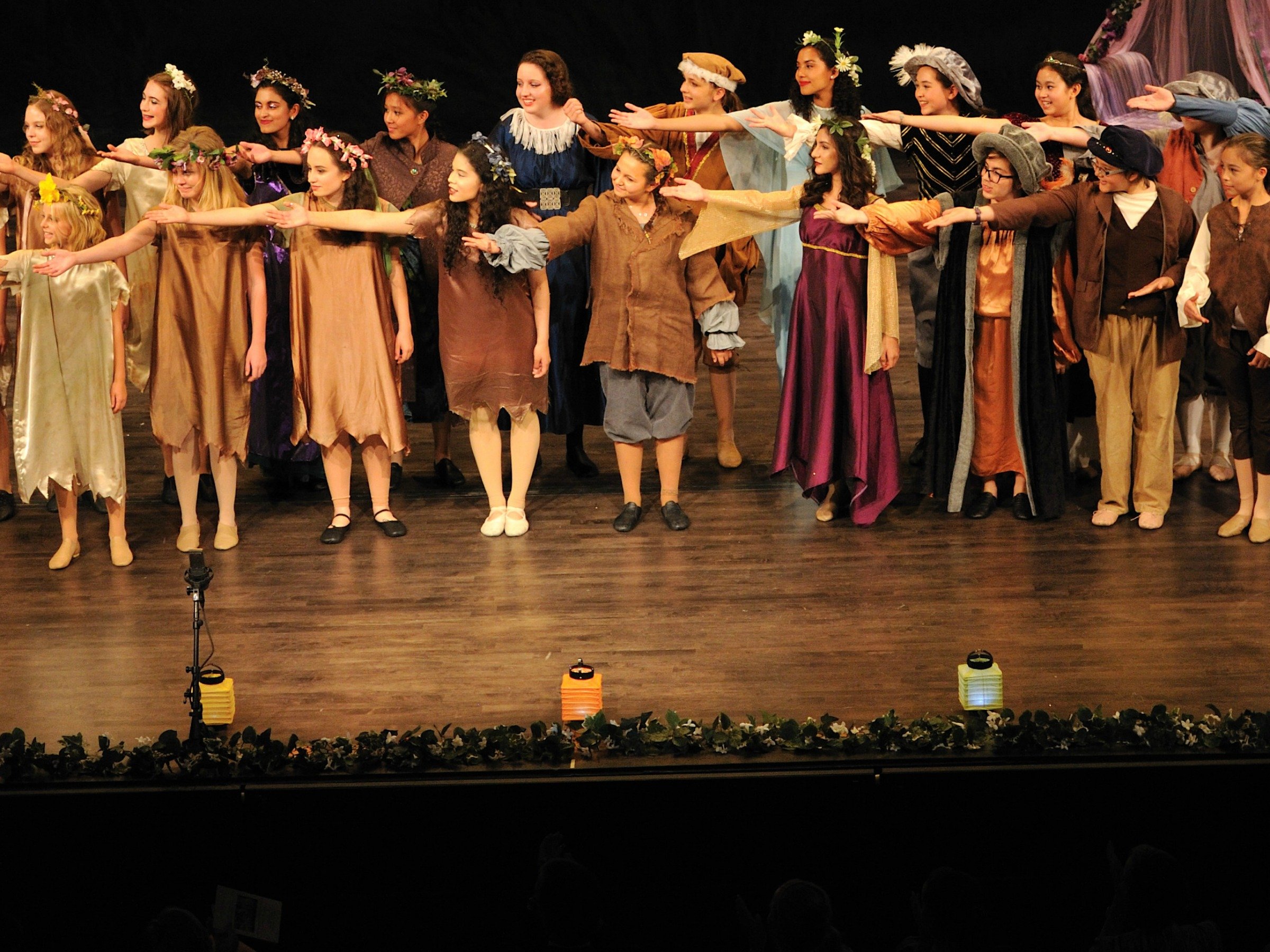 Summer Conservatory cast on stage with their arms out to their right