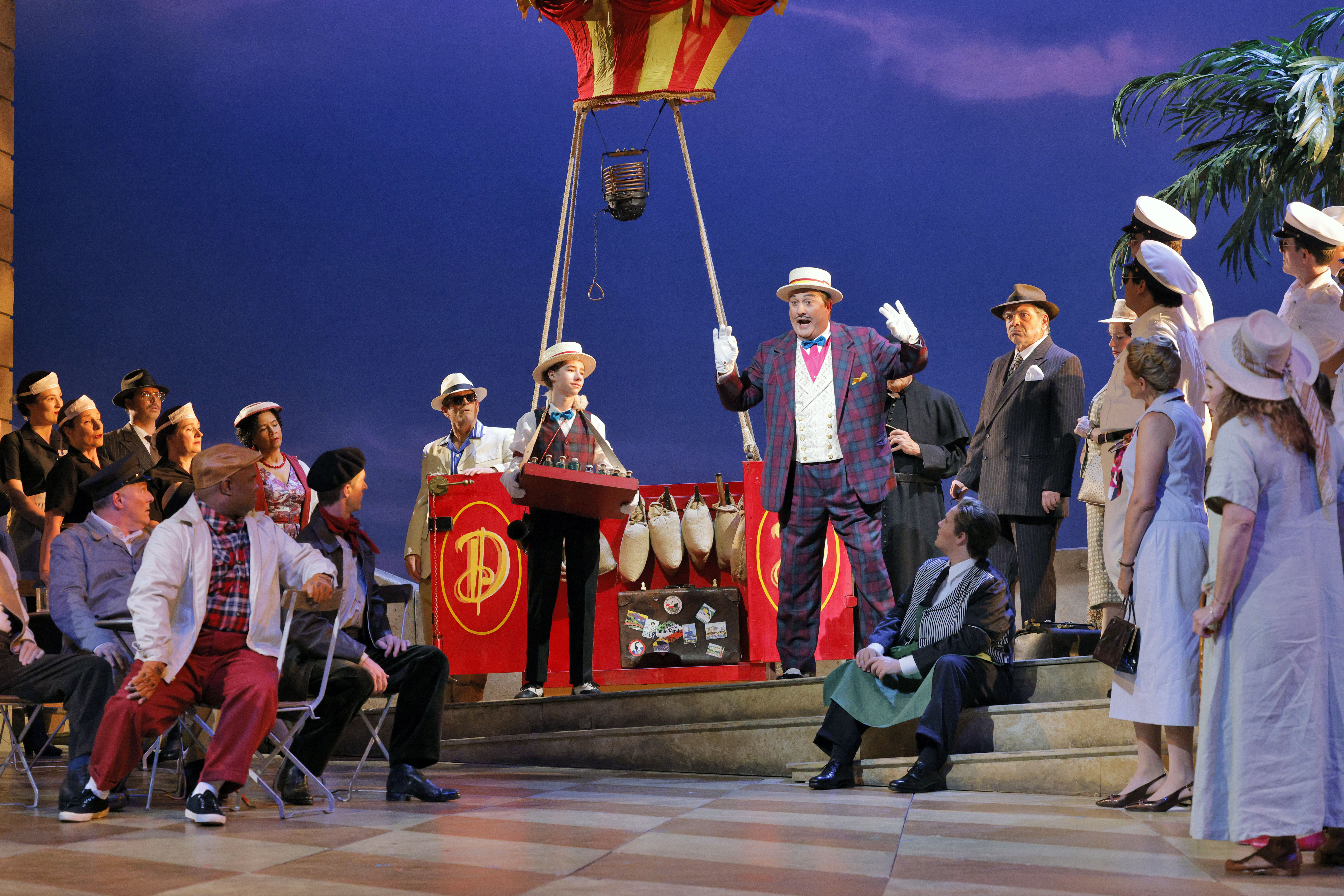 amn in plaid suit standing in front of balloon