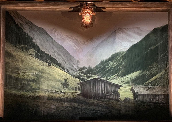 The Hansel and Gretel show drop featuring a stylized painting of a turn of the century German mountain cottage, inspired by imagery from that period. (Note the fabulous cuckoo clock that frames the opera throughout!). 