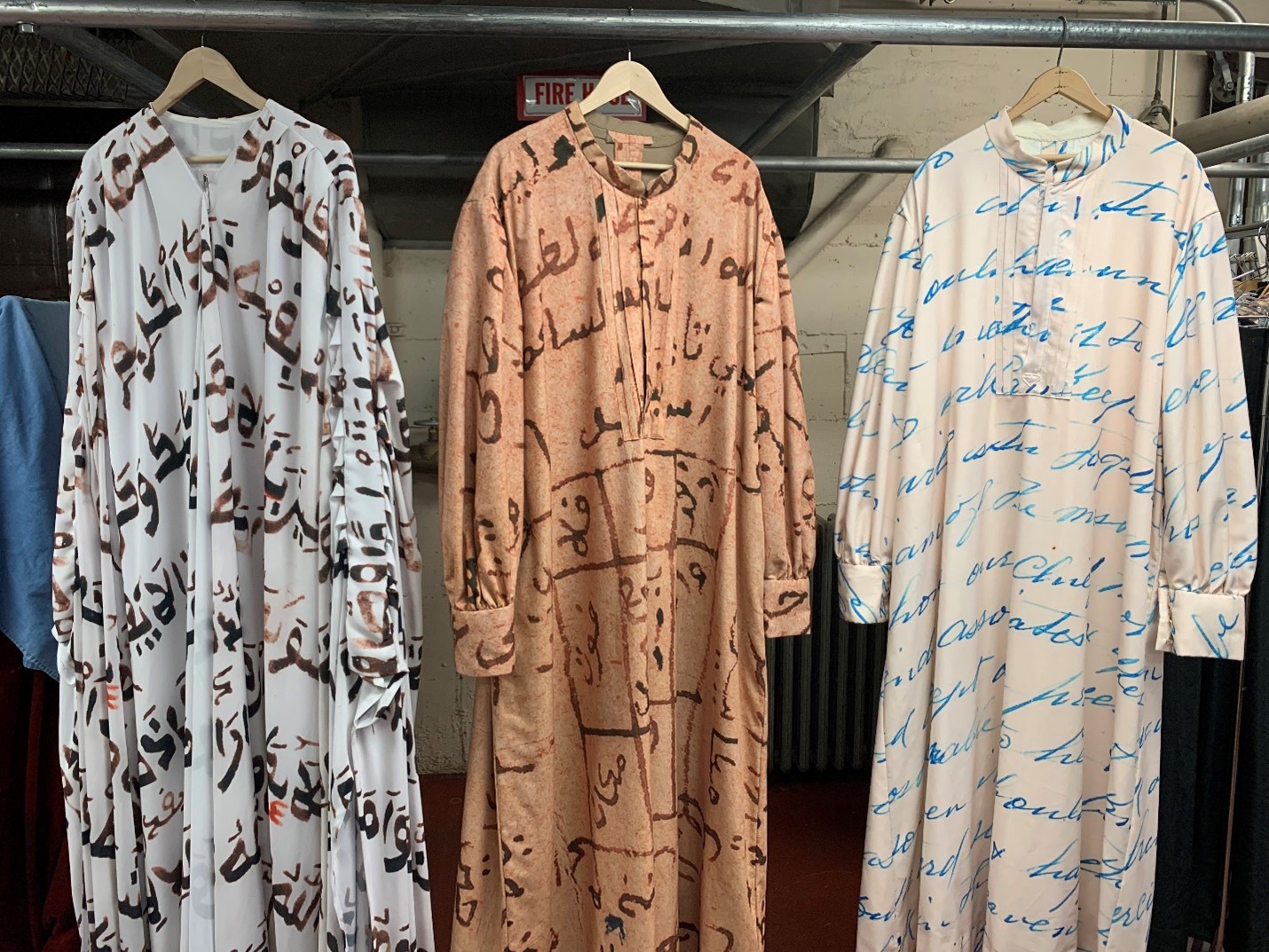 A selection of Omar’s costumes, including script in his hand (right and middle) 
