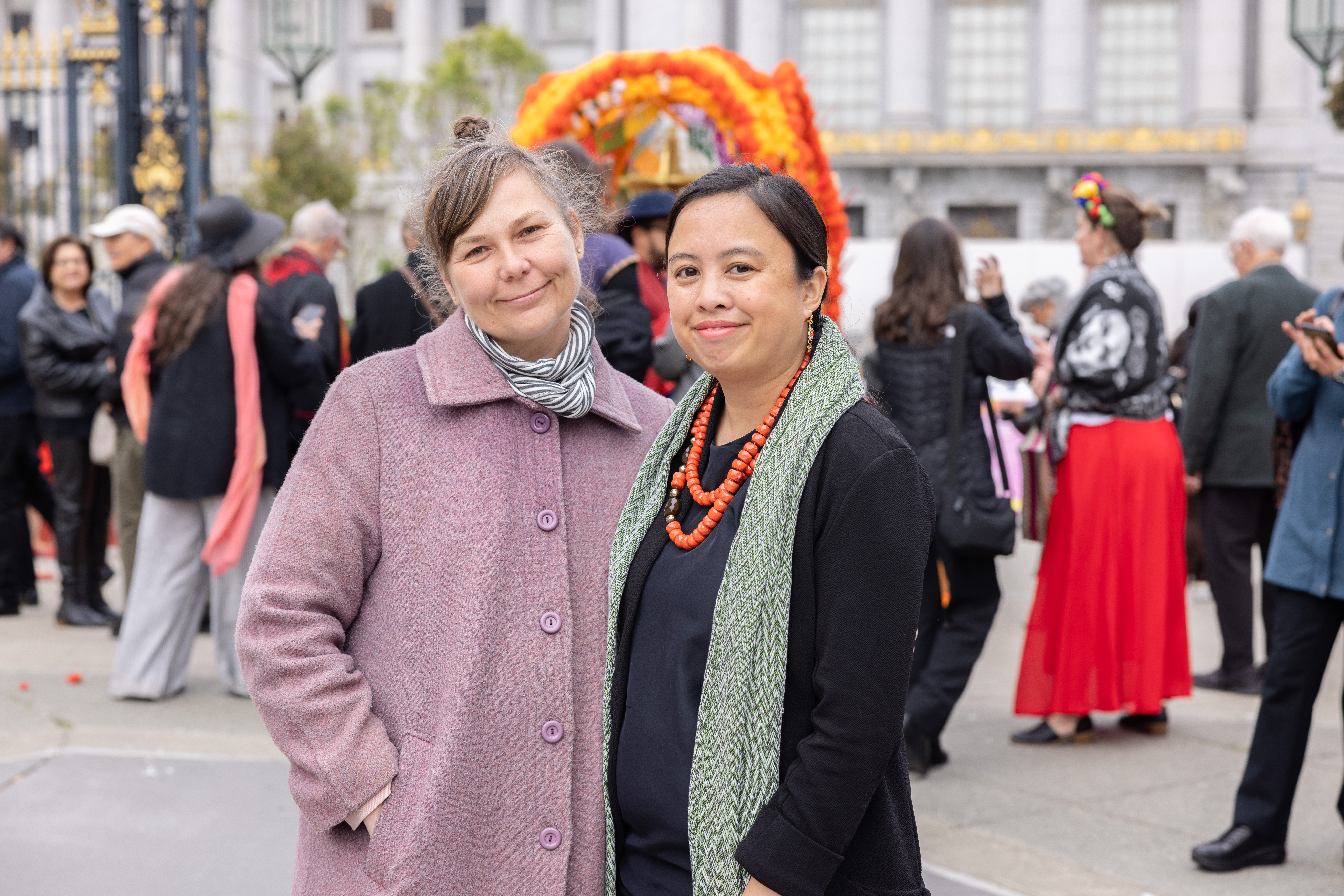two women smiling in front of the alter