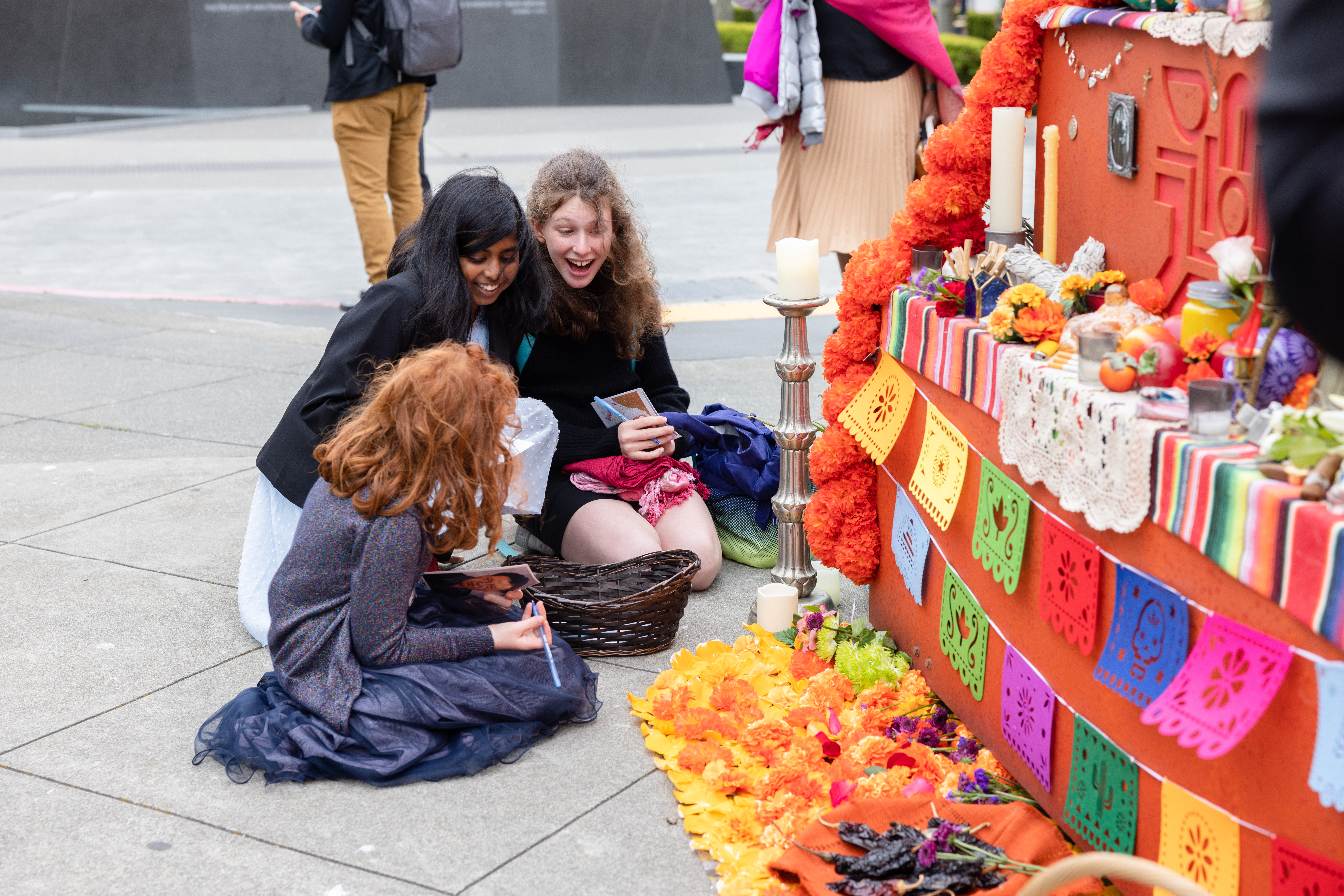 Youth writing prayers to put in basket at alter