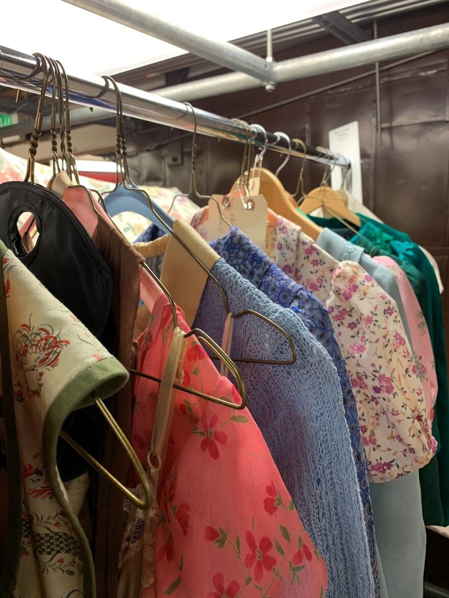 Andriana Chuchman&rsquo;s costumes for Mary Hatch, arrayed on a rack in the basement of the Opera House.