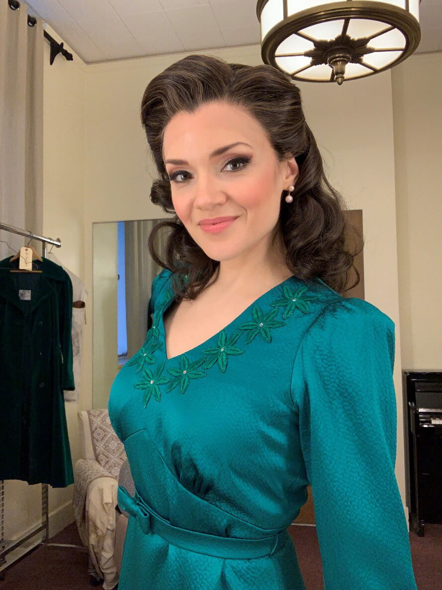 Andriana is in her dressing room, ready to end the show in the electric green dress. (Photo courtesy of Andriana Chuchman.)