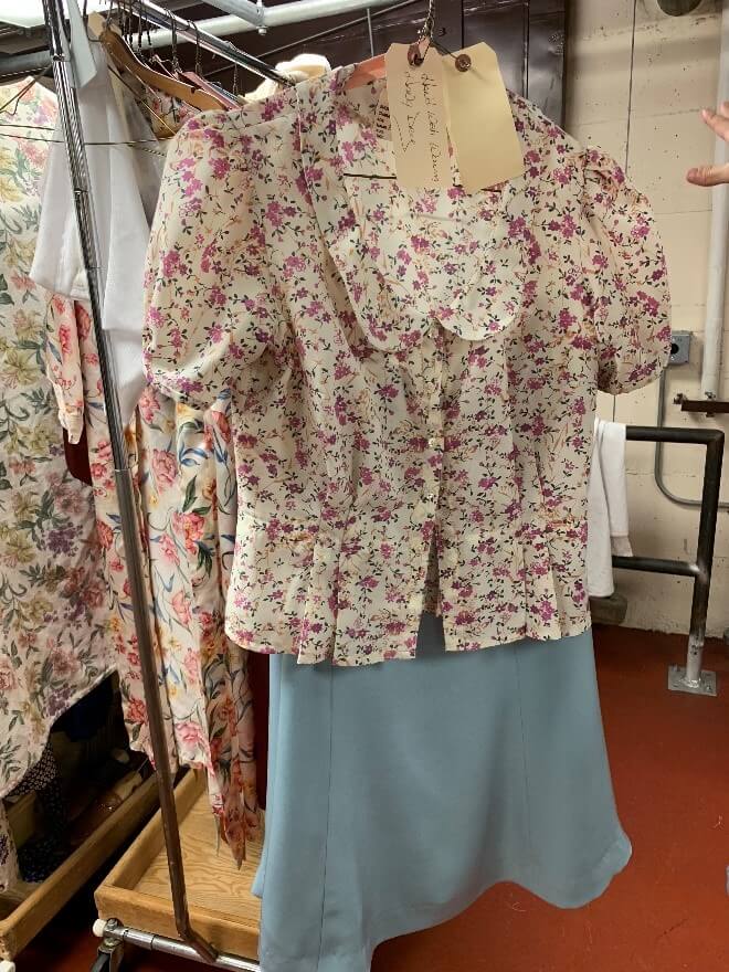 Act 2 begins with this wedding suit and floral blouse, held here by Jai Alltizer.