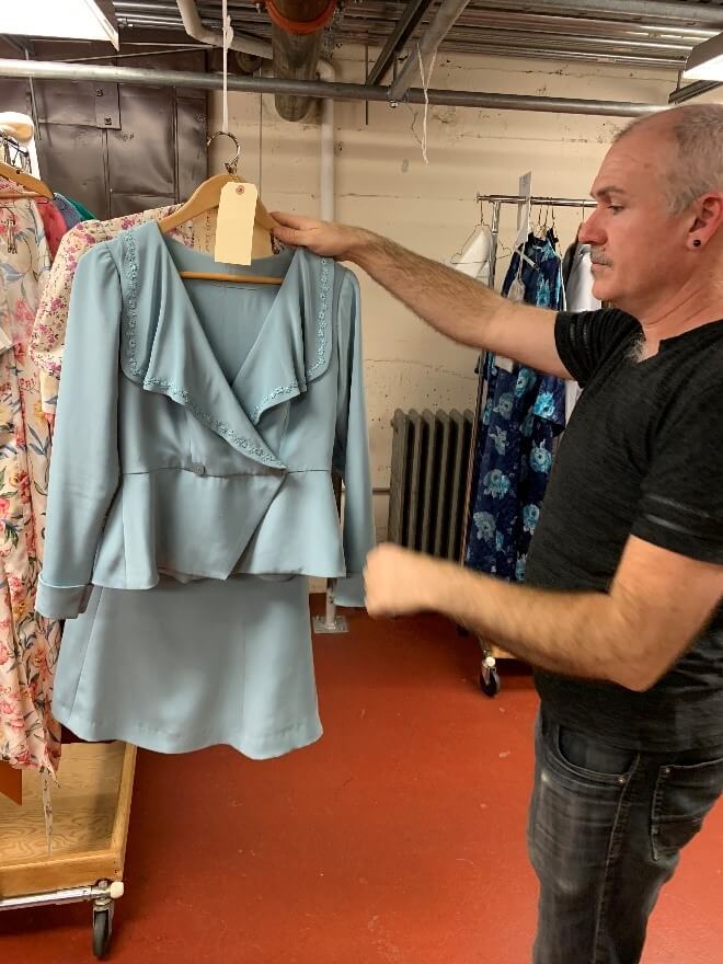 Act 2 begins with this wedding suit and floral blouse, held here by Jai Alltizer.