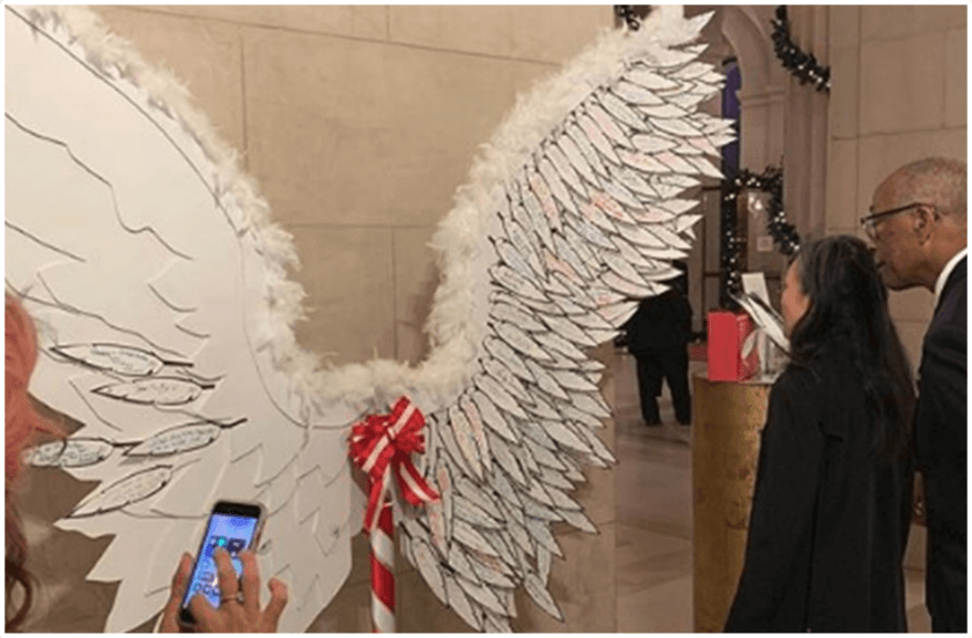 Patrons engaging with our angel wings filled with notes of good deeds.