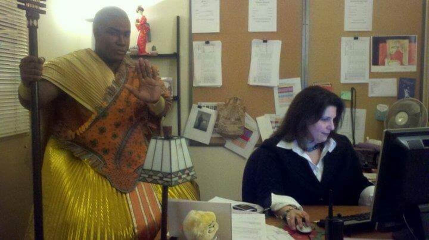 Marin Venturi working while Eric Owens (Ramfis in Aida) perches on a stool.