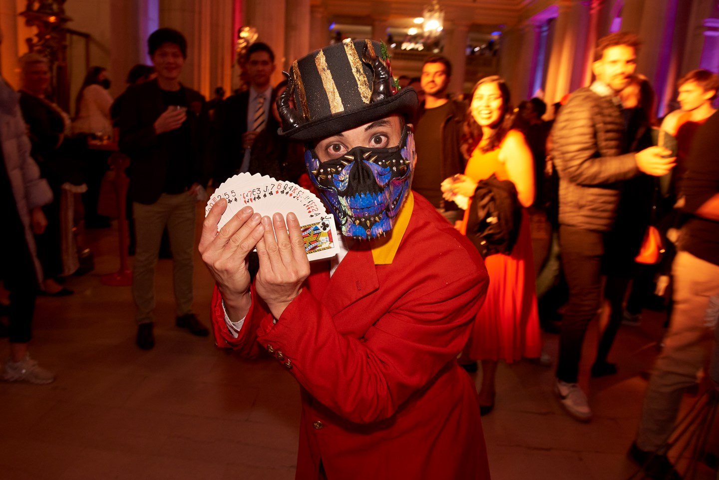 magician holding up a deck of cards