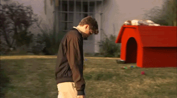 Arrested Development character George walking past a dog house with his head down gif