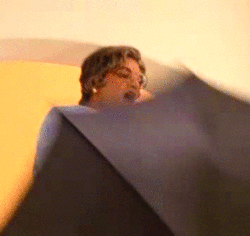 Arrested Development scene where a character jumps from the top of the stairs with an umbrella