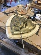 A Tosca crest in process in the prop shop.