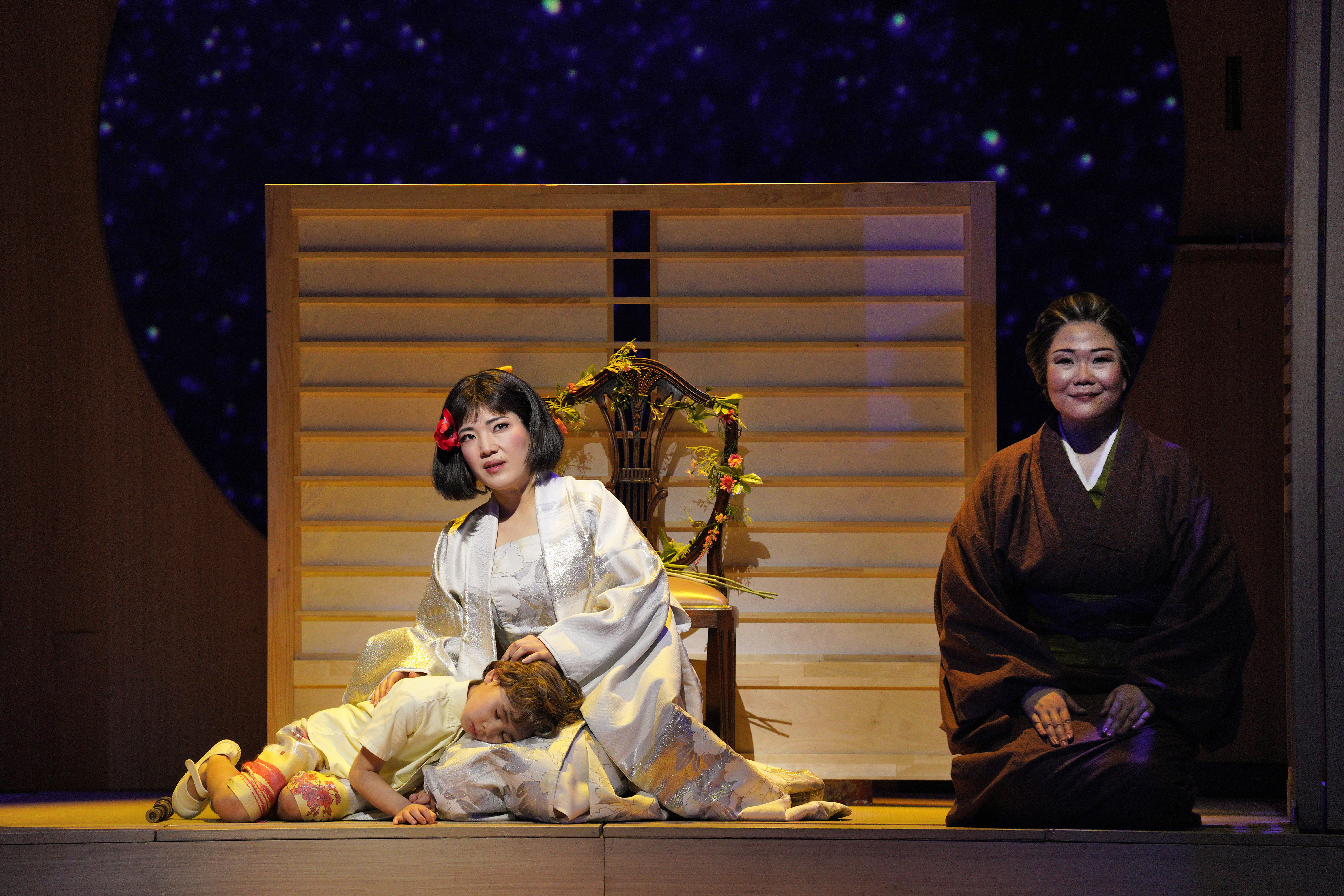 Child laying on woman's lap