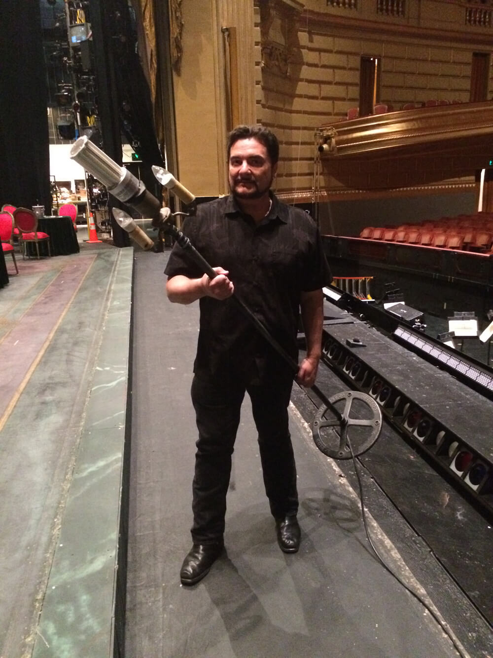 John prepares to set out the ghost light before closing down the theater.