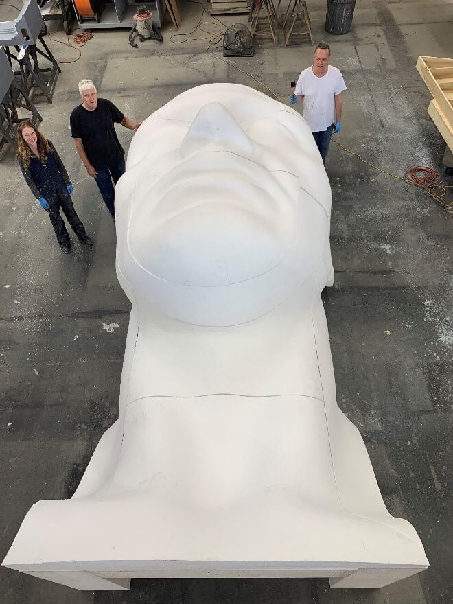 Our Scenic Artists led by Steve McNally (center) with the large 18-ft high head they are sculpting for Don Giovanni.