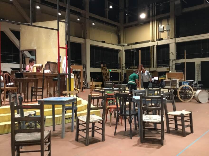 The frame of Mamma Lucia&rsquo;s bar in the Caminito in staging rehearsals in Zellerbach Rehearsal Hall, as Jill Grove, Dimitri Platanias and Lianna Haroutounian rehearse.