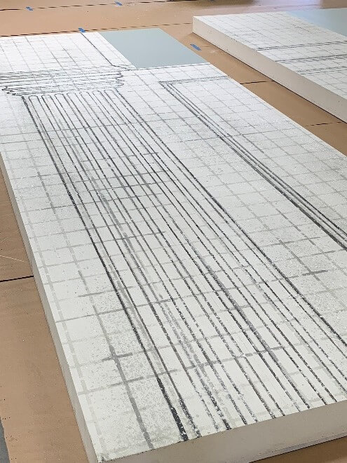 The table-sized stencil used to paint the graph lines onto the set was also created by the CNC router.
