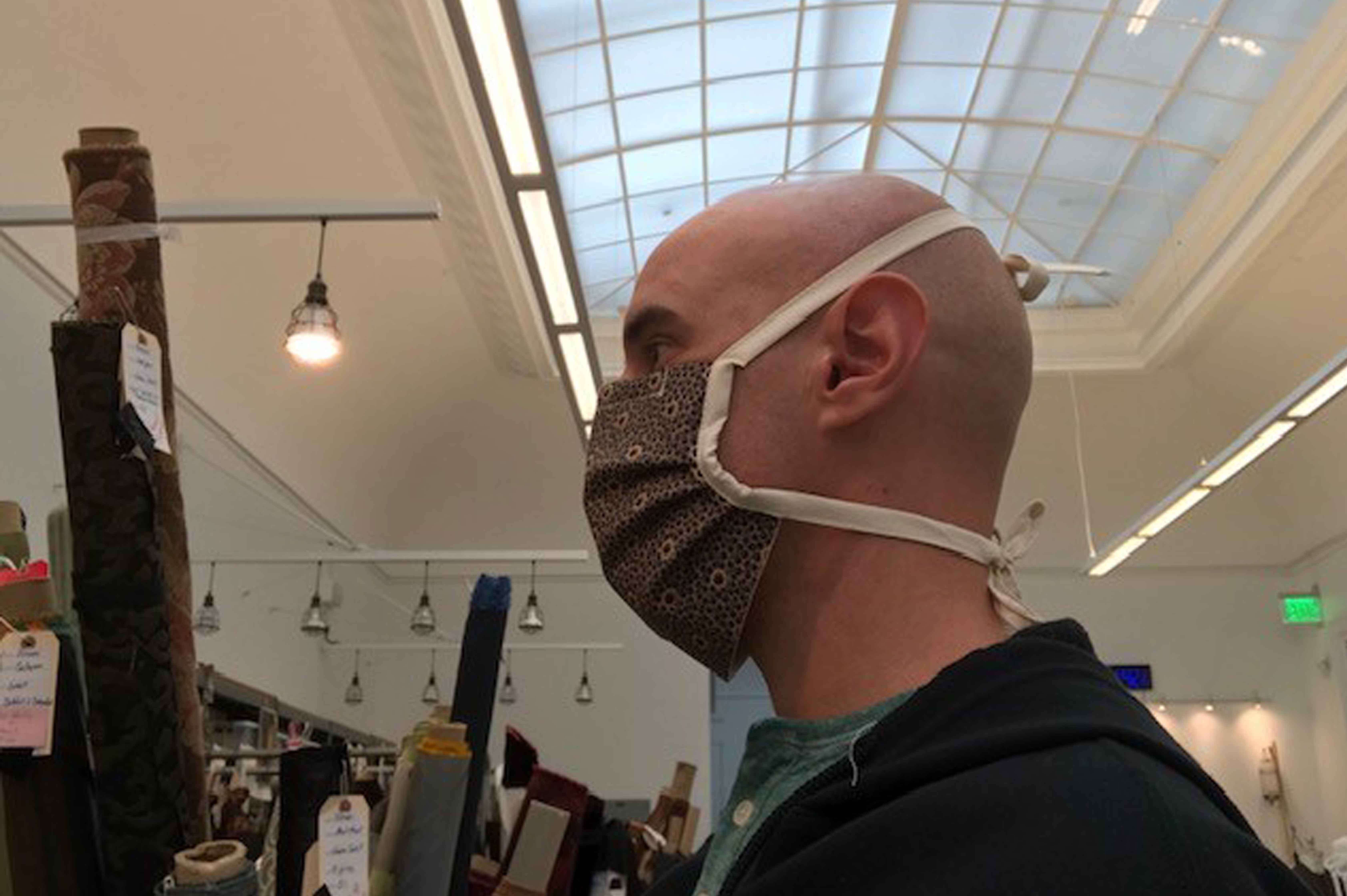 Men&rsquo;s Draper Santiago Suanes wearing one of the finished masks (using fabric from John Adams&rsquo; Girls of the Golden West). 