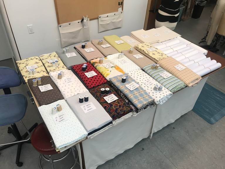 Fabrics being prepared for delivery, complete with matching threads.