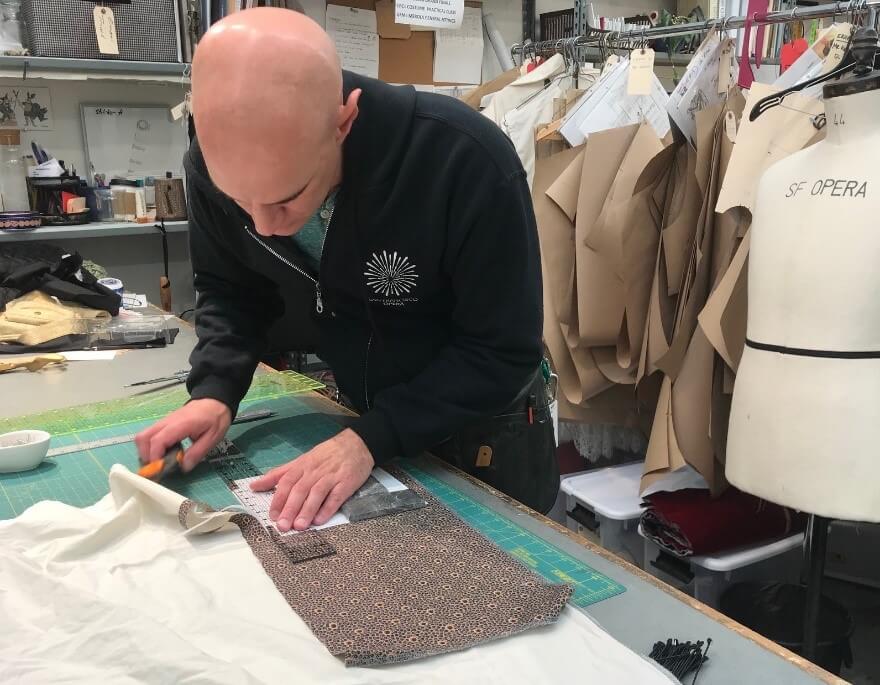 Santiago Suanes preparing and cutting the fabric for each mask. 