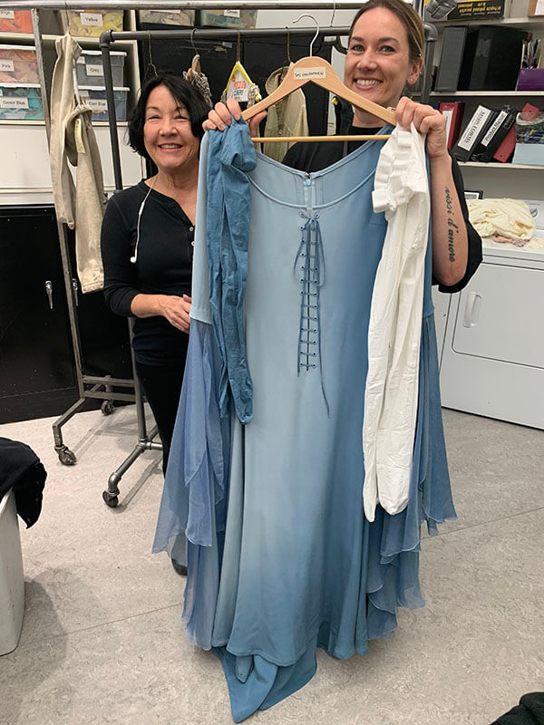 Amy van Every and Galen Till with the Rapunzel costume and a pair of already-dyed tights on the left and a pair of white tights on the right waiting to be dyed.&nbsp;