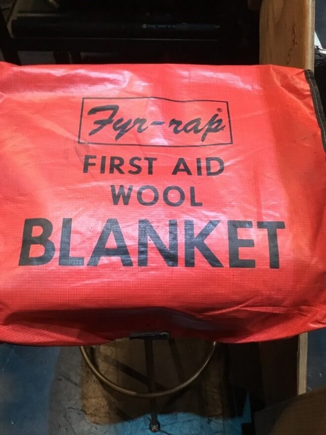 A fire blanket on hand if needed. This is actually the one used to douse the fire at the end of Götterdämmerung. It is just a pure wool blanket without any chemicals in it.