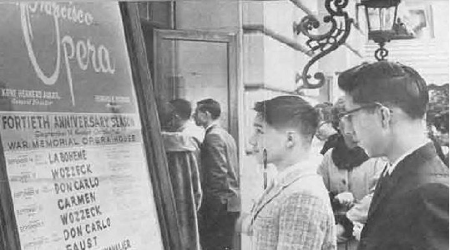 1979 Black and white photo of people looking at fortieth anniversary show sign outside of opera house