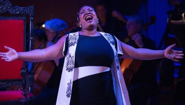 Merola artist singing with arms open wide