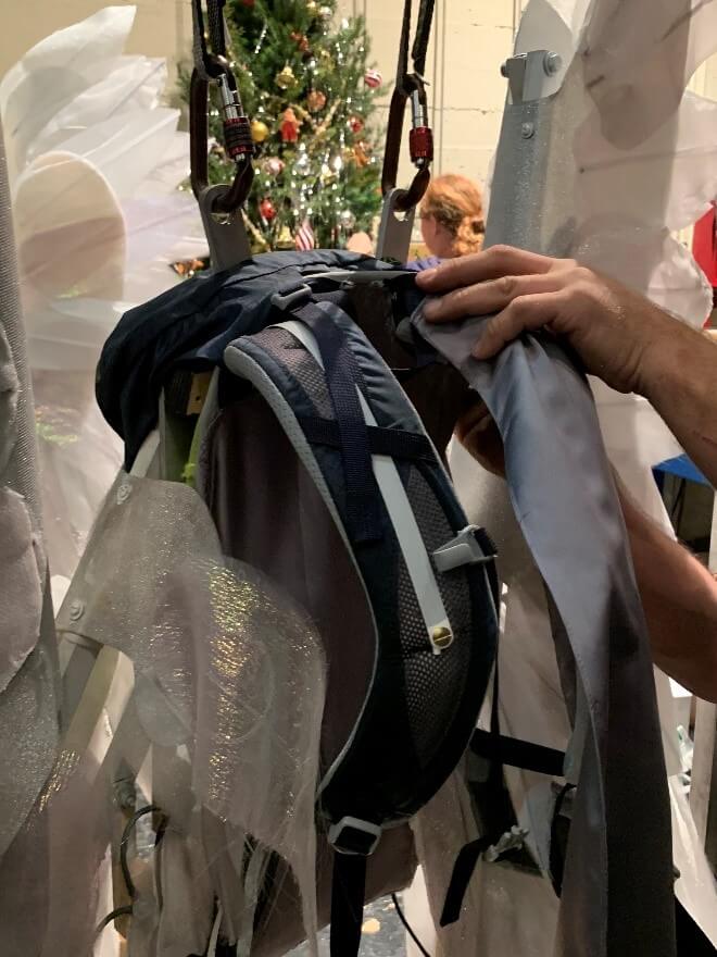 The new format harness made out of a backpack and showing the whalebone white strip that keeps the straps extended.