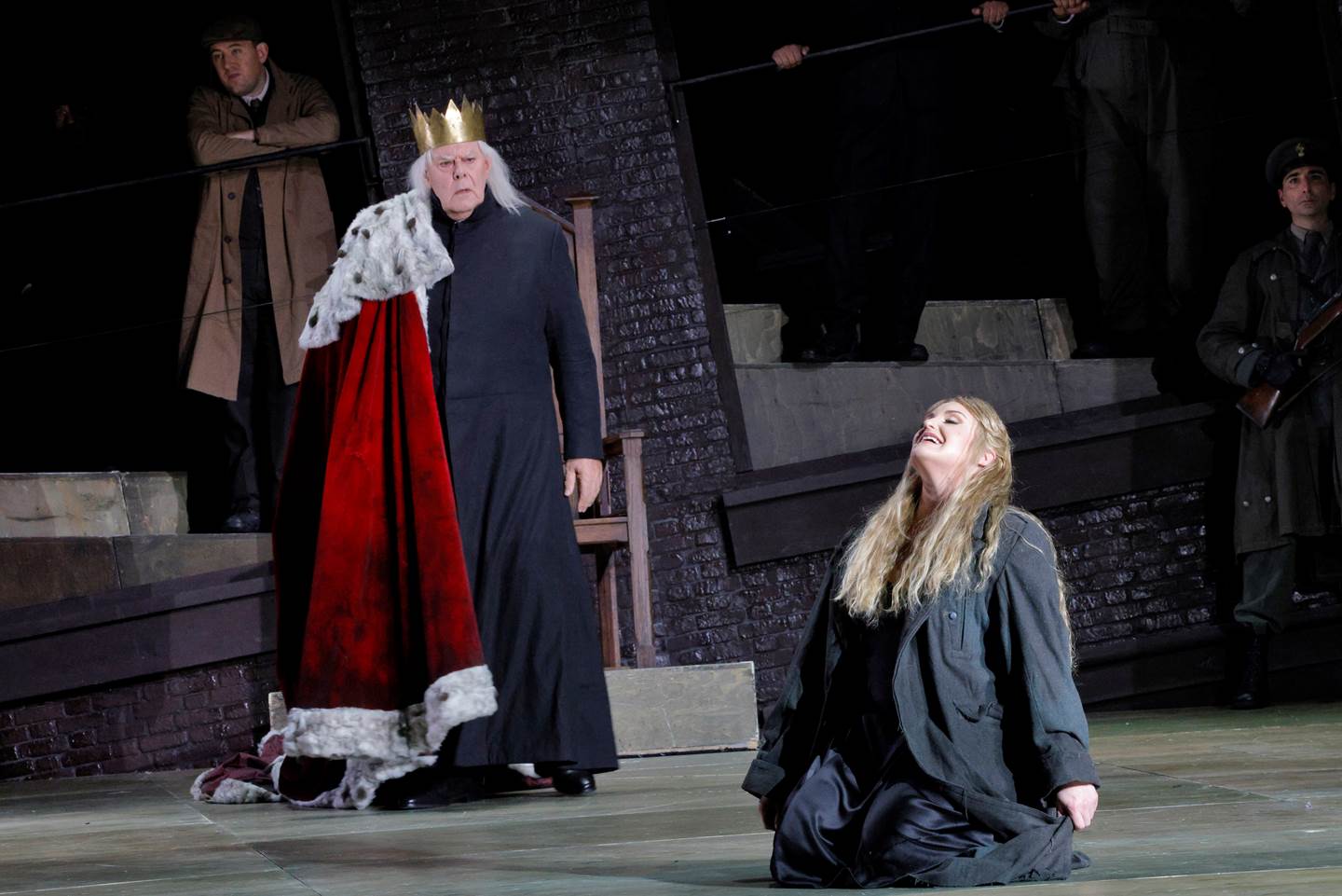 women kneeling on ground in front of king with her head heald high