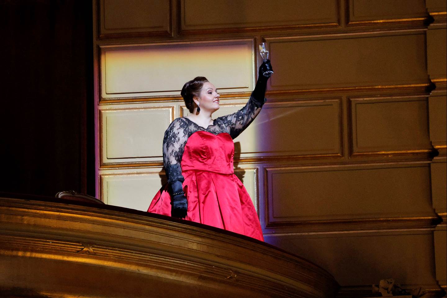 women holding status from balcony