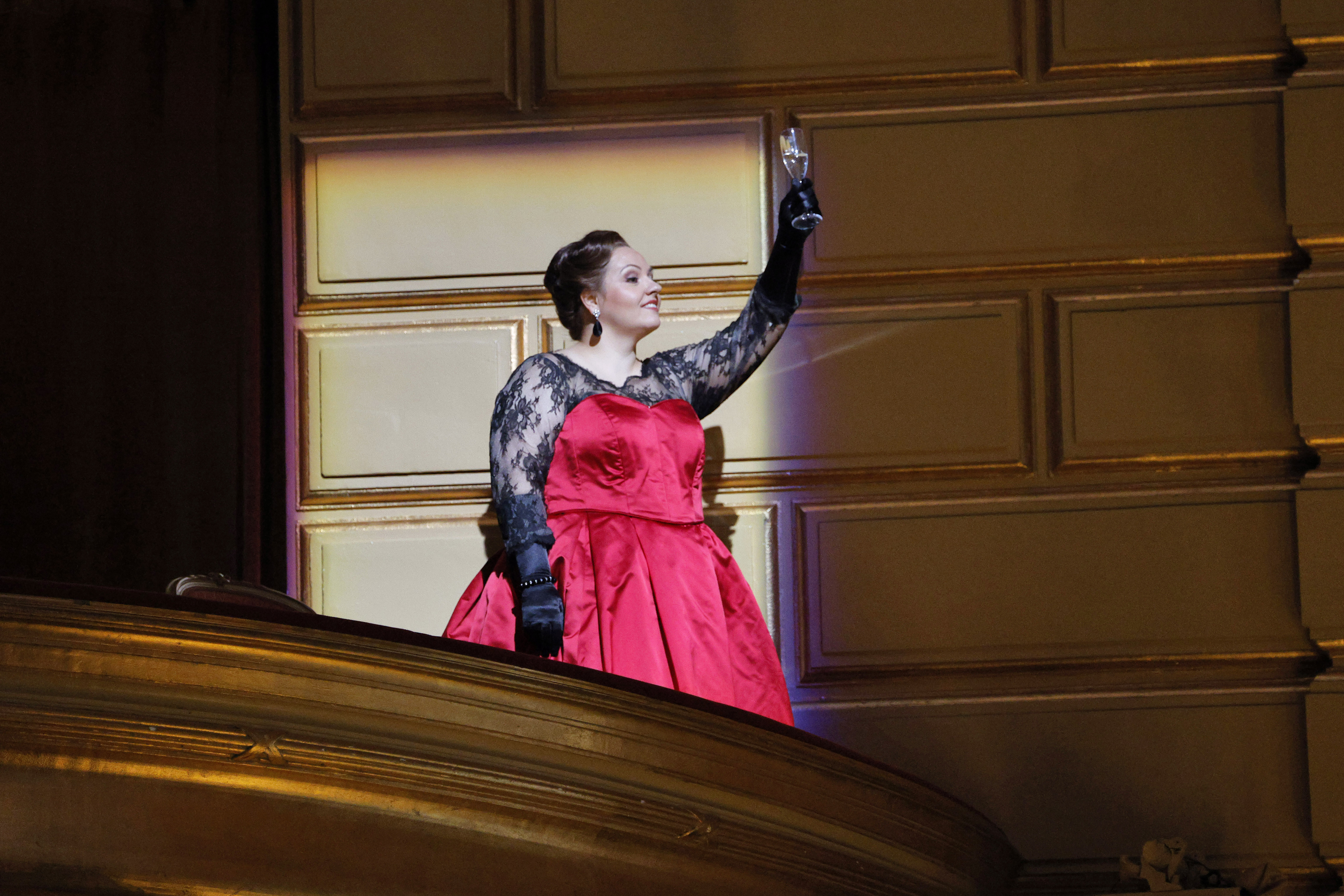 women holding status from balcony