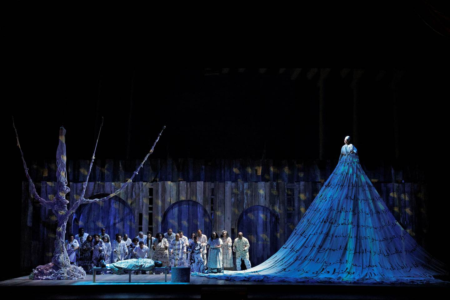 woman in a long blue dress elevated on stage