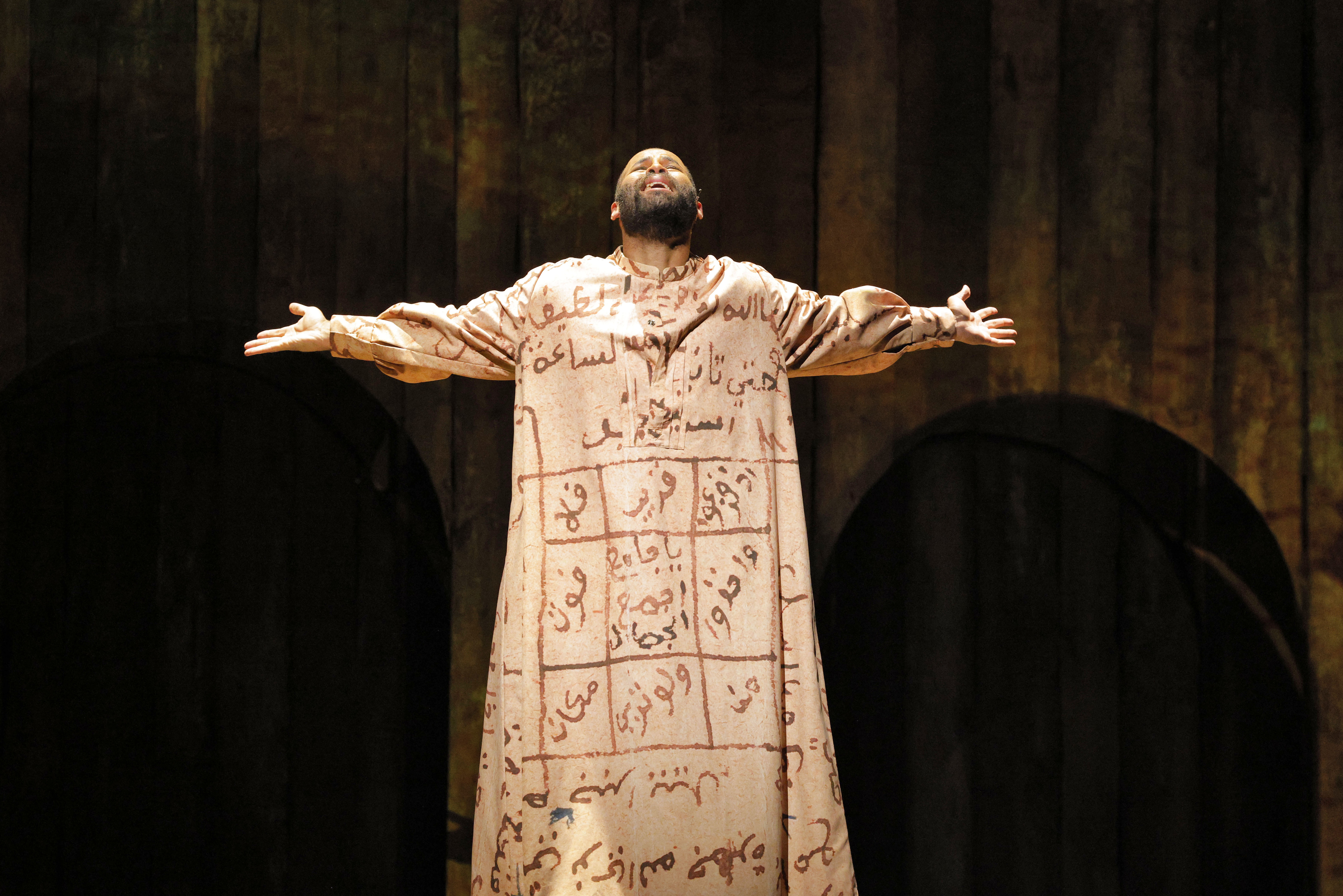 man singing with his arms outstretched