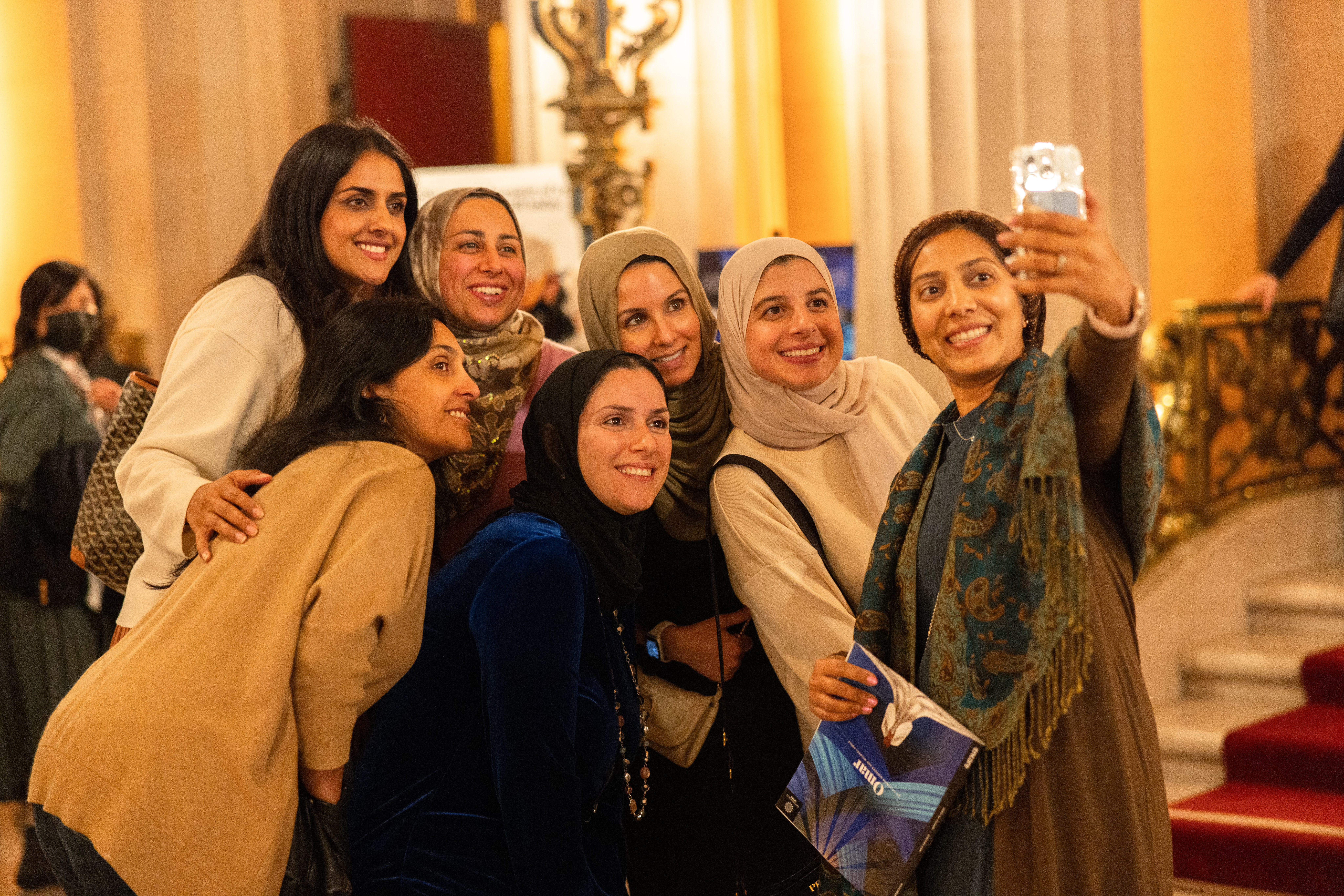 Women gathered and smiling for a selfie