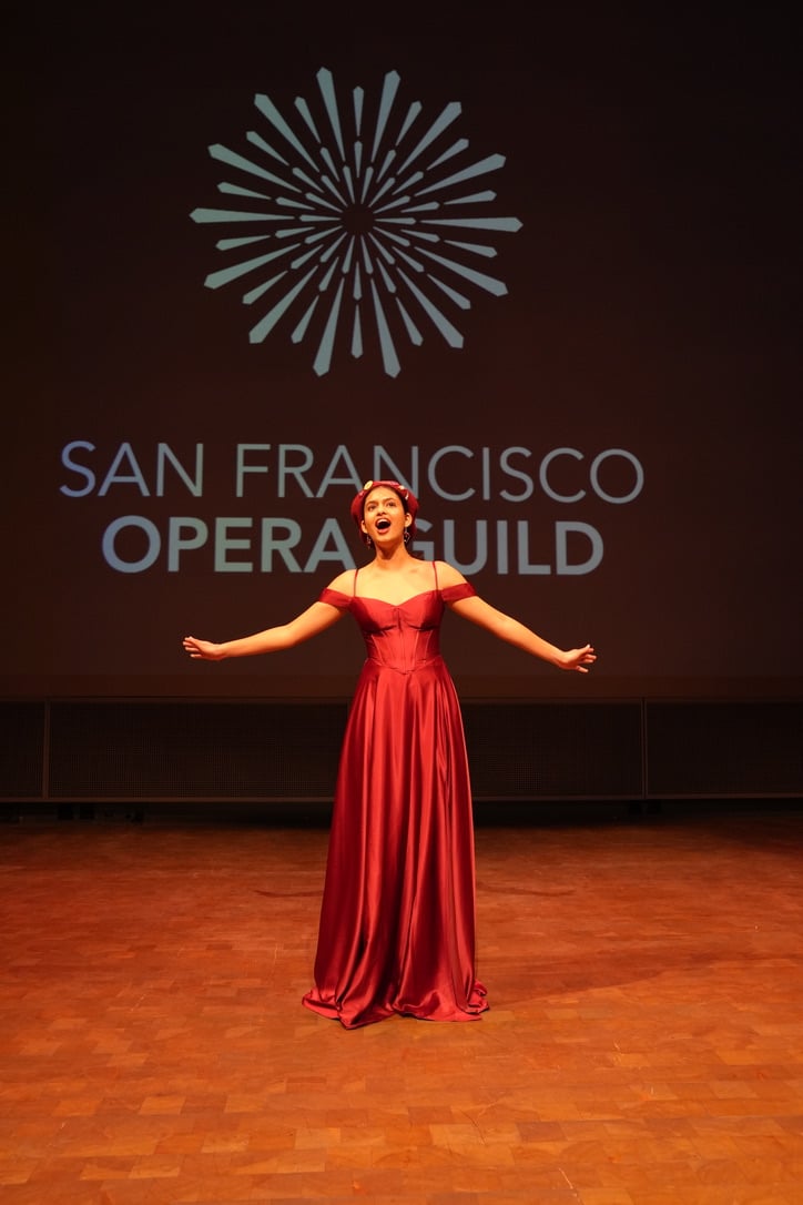 Girl singing in long red gown