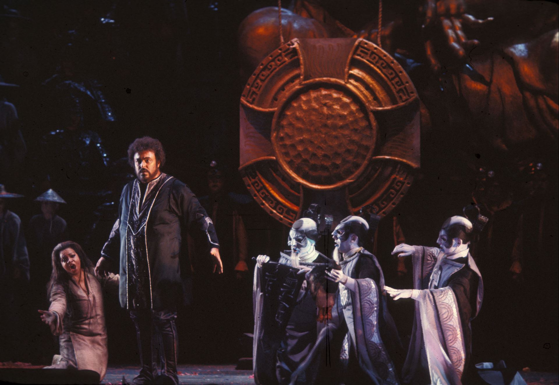 A group of people in costumes standing on a stage, captured in a captivating streaming performance.